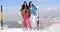 Two female snowboarders standing on a mountain