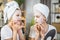 Two female teenagers using cosmetic mask for face