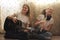 Two female teens with smartphone and musical instruments sitting on the floor at home