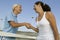 Two female Tennis Players shaking hand over tennis court net low angle view