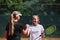 Two female tennis players shaking hands with smiles on a sunny day, exuding sportsmanship and friendship after a