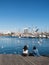 Two female tourists rest surrounded by seagulls in the old port of the city of Barcelona. Catalonia, Spain