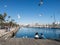 Two female tourists rest surrounded by seagulls in the old port of the city of Barcelona. Catalonia, Spain