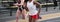 Two female track sprinter runners competing on an indoor track