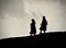 Two female walking on a hill track path isolated silhouette photograph