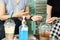 Two females customers talking at coffee shop  with alcohol gel on table, new normal concept