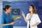 Two females doctor discuss their work with electronic medical re