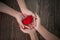 Two females people stack their hands together with red heart, with feelings of delivering or receiving love, care, safe