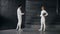 Two fencers man and woman have greeting each other and start fencing match indoors