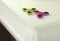 Two fidget spinners pink and green stress relieving modern popular toys on white shelf closeup