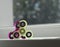 Two fidget spinners pink and green stress relieving toys closeup modern popular