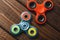 Two Fidget Spinners popular trend stress relieving toy on wood