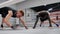 Two fighters are training on ringside make exercises in plank in fight club.