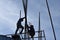 Two Filipino Construction steel workers assembling steel bars on high-rise building with no proper protective suits and safety sho