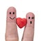 Two fingers are symbols of love couples,one red heart of