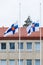 Two finnish flags lowered to half mast on the occasion of mourning at cloudy autumn day