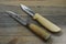 Two Finnish traditional knives puukko on a wooden background