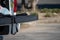 Two firearms sitting on the tail gate of a pickup truck during a search of a vehicle.