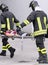 Two firefighters carried the injured away on stretchers