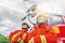 Two firefighters in protective clothing, helmets and mask against fire engine posing against fire truck background