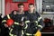 Two firefighters in protective suits standing