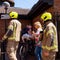 Two Firemen Or Firefighters Dressed In Safety Clothing