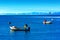 Two fishermen on boats in the Adriatic Sea on a winter evening