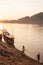 Two fishermen with fishing nets in the Mekong River at sunset. S