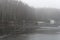 Two fishermen on the ice of a recently frozen pond