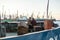 Two fishermen on an industrial vessel fish in the evening for leisure Odessa port Ukraine May 2015