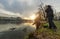 Two fishermen trying to catch fish in river, urban fishing.