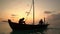 Two fishermen wash old boat at sunset in the Indian Ocean. Slow motion