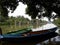 two fishing boats on a calm river surrounded by mangroves