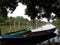 two fishing boats on a calm river surrounded by mangroves