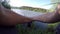 Two fishing lines catch fish on a lake bank with reed in summer