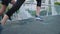 Two fit athletes running and jogging on a bridge in a city outdoors. Closeup on legs of a motivated man and woman