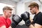 Two fit handsome men in gym boxing.