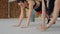 Two fit women doing exercises lying inside fitness studio