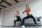 Two fit women doing squats at home Female workout sport and fitness.