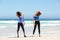 Two fit young women enjoying workout at the beach
