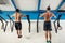 Two Fitness toes to bar men pull-ups tree bars workout exercise at gym