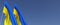Two flags of Ukraine on flagpoles on side. Flags on a blue background. Place for text. Independent Ukraine. Ukrainian state symbol