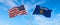 two flags of USA and state of Wisconsin waving in the wind on flagpoles against sky with clouds on sunny day