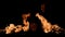 Two flames of fire blaze from different sides of screen in dark. Real bonfire, burner or torch flashes against black