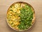 Two flavor pizza: Arugula and zucchini with corn kernels. Overhead, flat lay of meal.