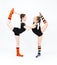 Two flexible teen girls doing gymnastics exercises on a white