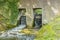 Two floodgates on a brick wall of a weir on the Jeker river in Maastricht city park