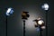 Two floodlights with halogen lamps and Fresnel lens and two led lighting device. Shooting in the interior on a gray background