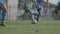 Two Football Teams Play Football on Green Stadium Field