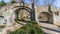 Two footpaths with an old stone bridge with two arches in the Proosdij park,